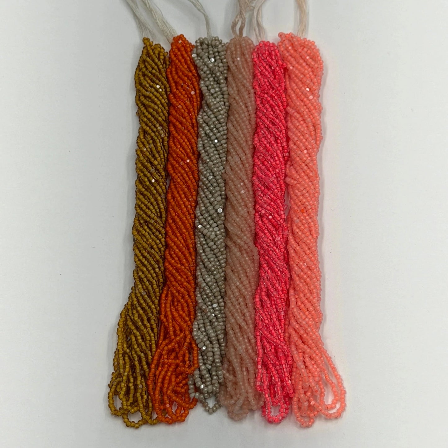 Set of five braided strings in different colors on a white background