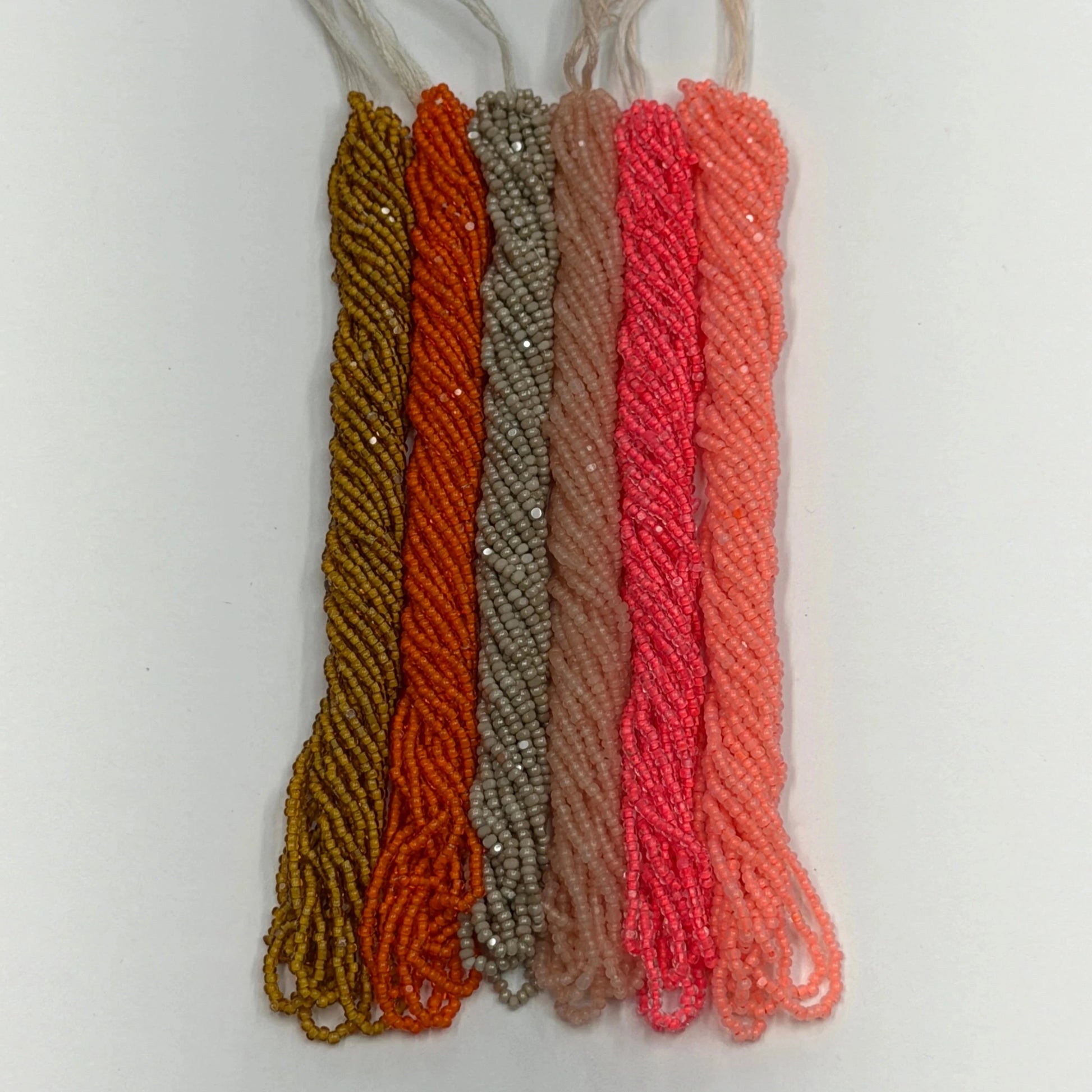 Set of five braided strings in different colors on a white background