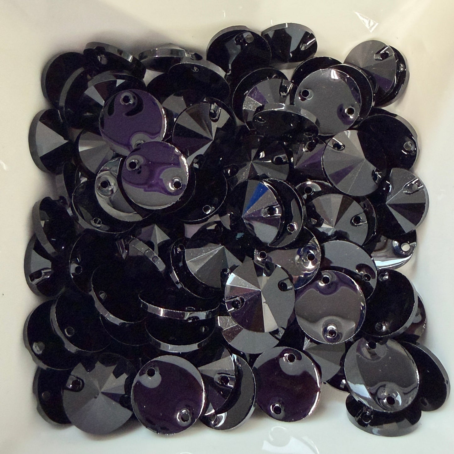 Black and purple sequins on a white background