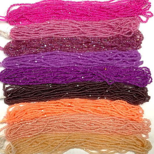 Set of colorful beaded strings in various shades on a white background