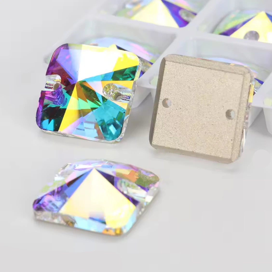 Colorful crystal stones with a plain stone on a white background