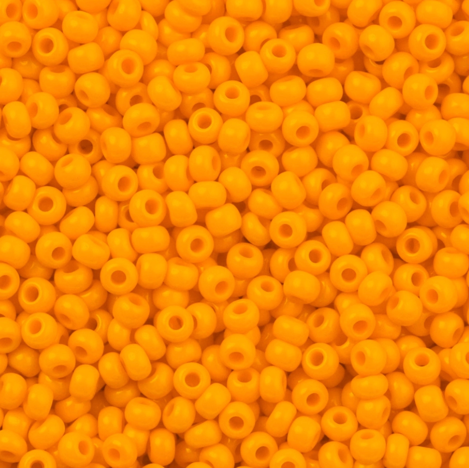 Close-up of yellow beads with a uniform color and shape.