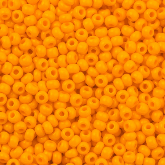 Close-up of yellow beads with a uniform color and shape.